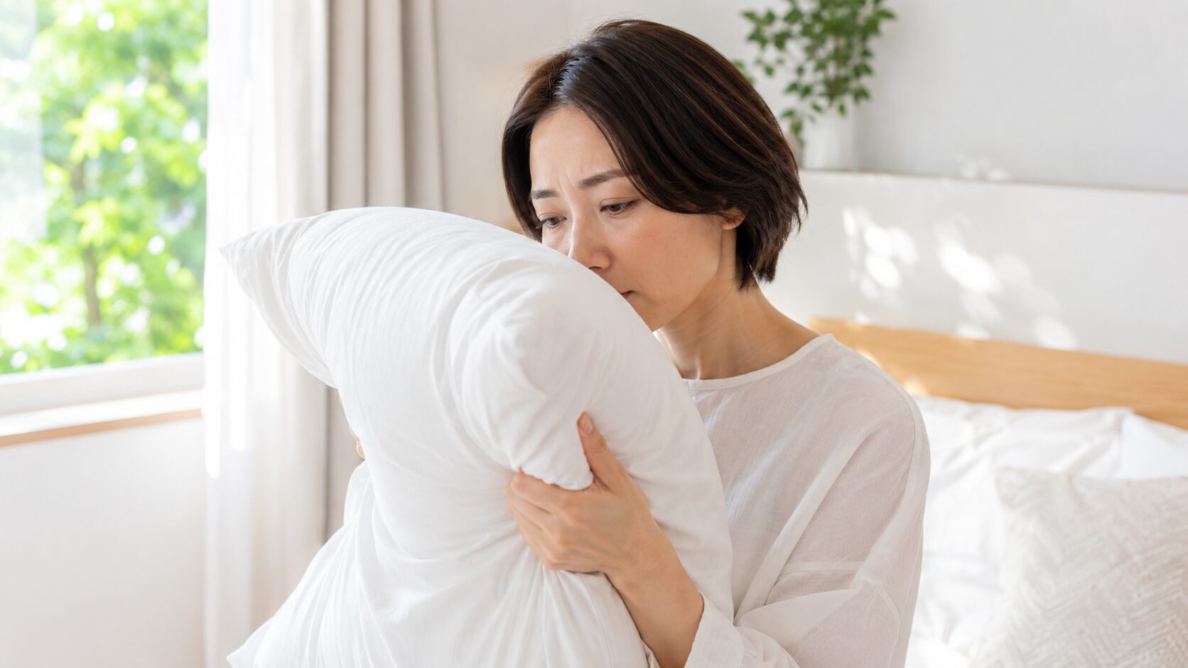 枕の臭いを確かめる女性｜朝の寝室での枕の臭いセルフチェック